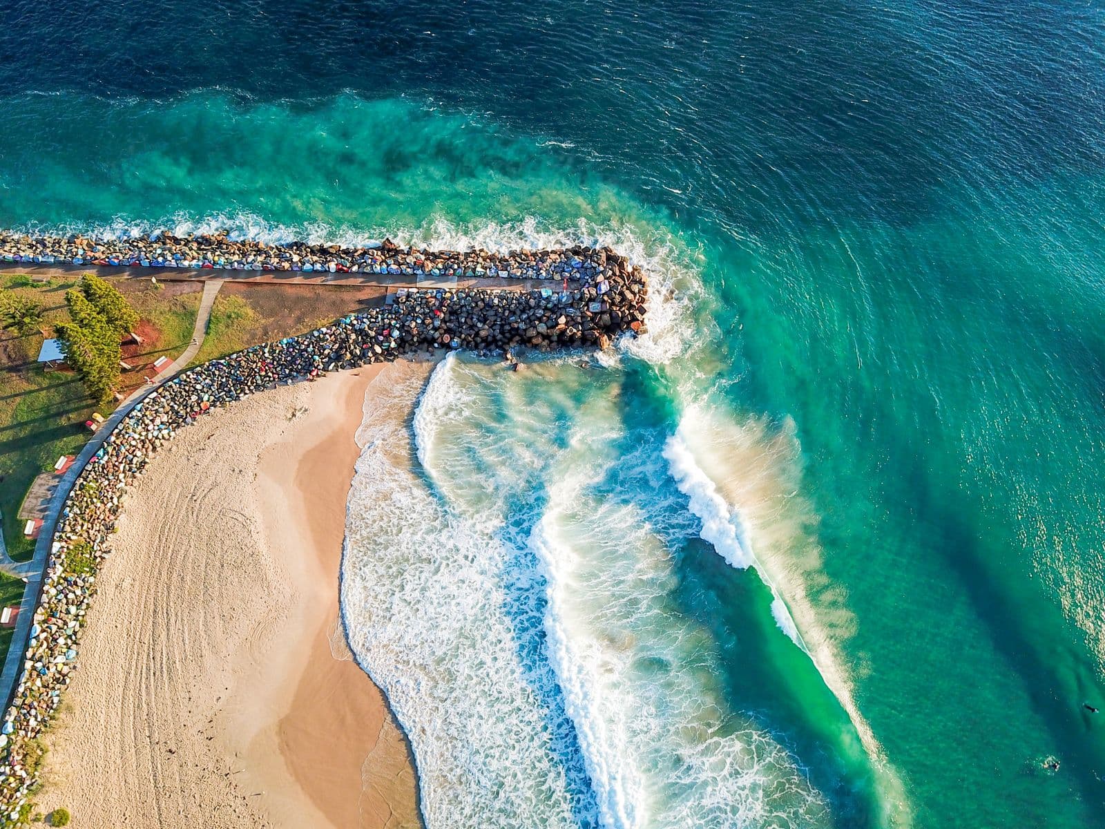 Waves breaking along the rocky Port Macquarie coastline, seen from above