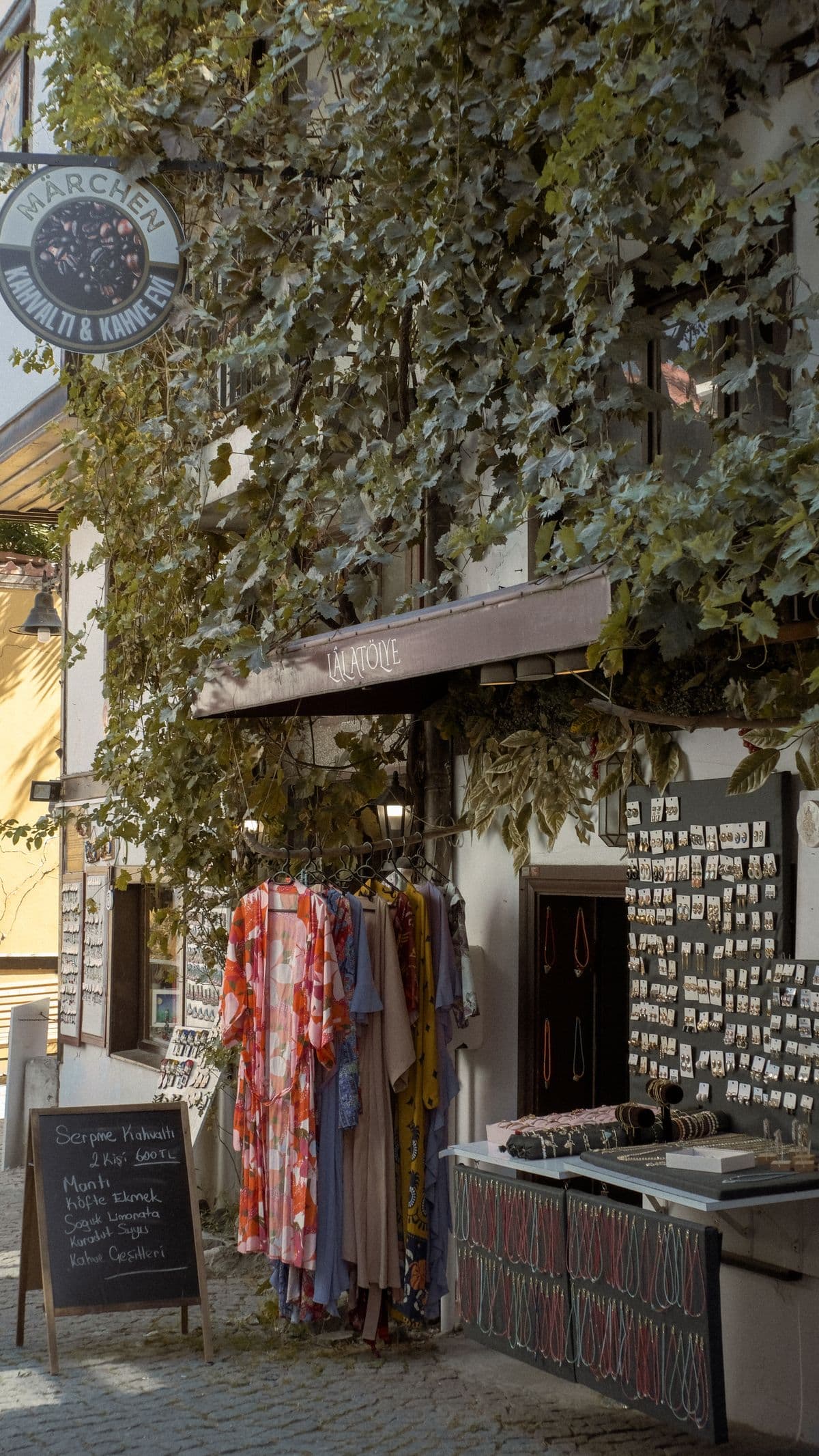 A small boutique shopfront with an ivy-covered facade