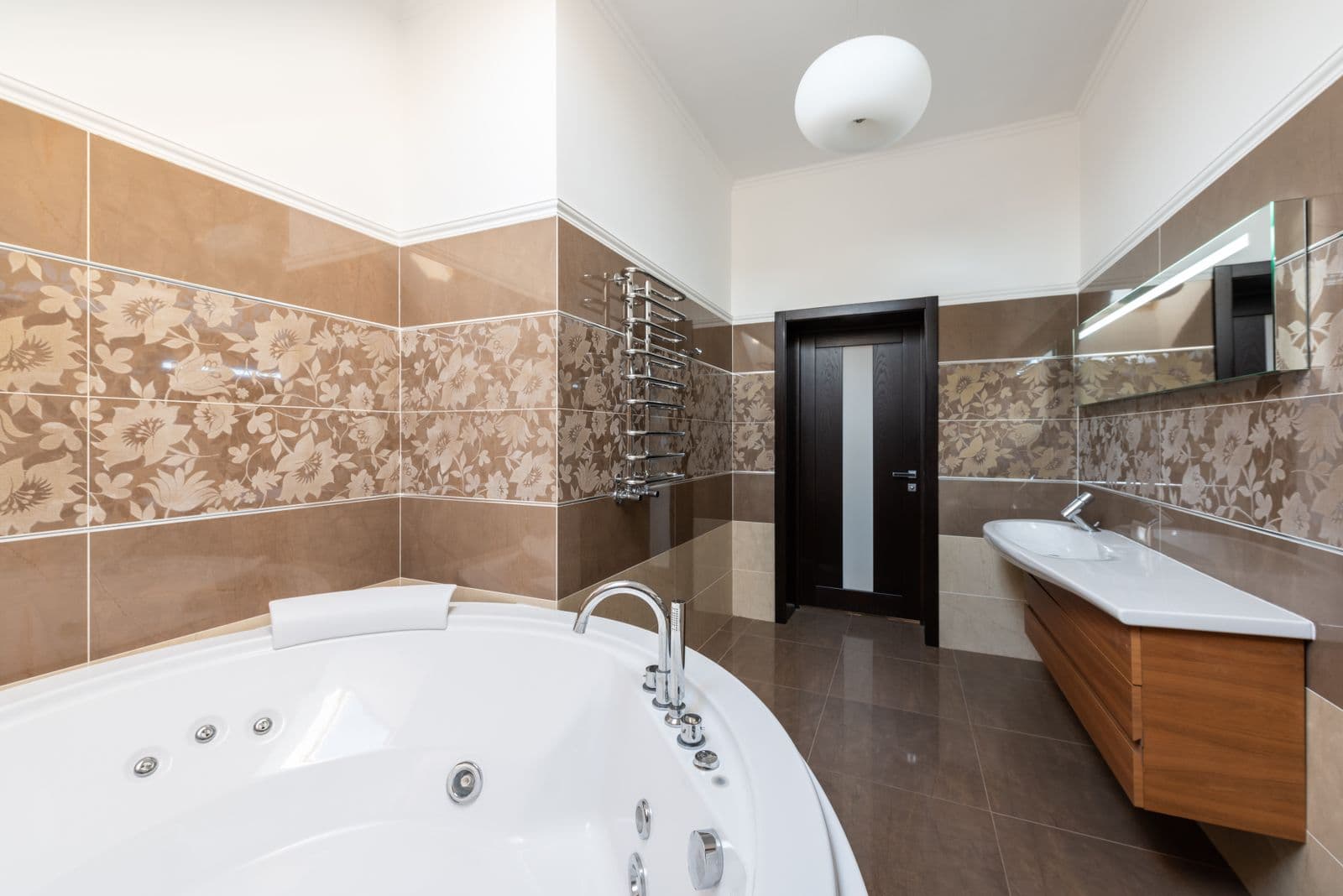 A bathroom with a freestanding tub and timber vanity