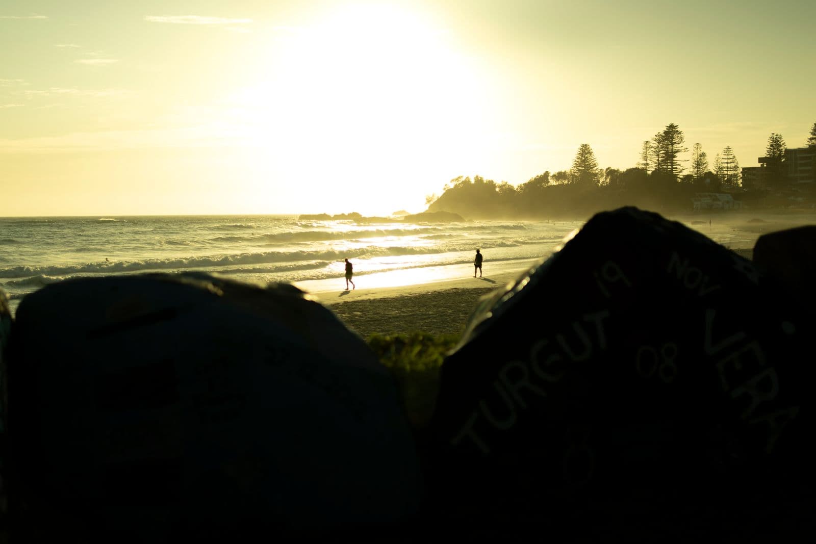 People silhouetted on a Port Macquarie beach at sunrise